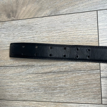 Moschino FW14 SpongeBob Leather Belt is a black leather belt from the Fall/Winter 2014 SpongeBob SquarePants collaboration. The front features the MOSCHINO logo formed by individual movable letters rather than a single rigid buckle. Each letter is finished in yellow with green sponge-like detailing, and the first “O” includes SpongeBob’s happy face. The belt uses a metal buckle closure and comes with the original dust bag and tags. Made in Italy from Genuine Leather.