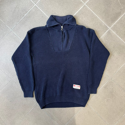 Mustang Jeans Navy Troyer Sweater is a heavyweight, high-quality navy troyer sweater featuring a Mustang Jeans patch tag on the lower front and a silver-colored horse zipper pull. The design includes a collar typical of the troyer style.