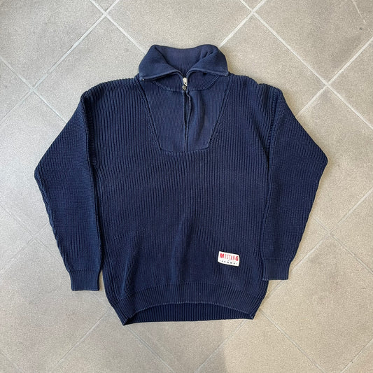 Mustang Jeans Navy Troyer Sweater is a heavyweight, high-quality navy troyer sweater featuring a Mustang Jeans patch tag on the lower front and a silver-colored horse zipper pull. The design includes a collar typical of the troyer style.