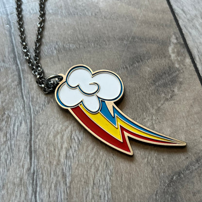 My Little Pony Rainbow Dash 2010s Necklace produced by WeLoveFine. Constructed from stainless steel, it features a slightly raised steel outline pendant of the Rainbow Dash cloud and three-color lightning bolt logo, finished with enamel detailing. The pendant is attached to a thin stainless steel chain.