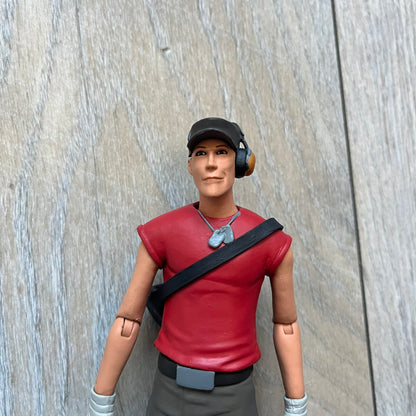 NECA Team Fortress 2 RED Scout Series 4 action figure from 2018. The figure measures approximately 7 inches in scale and recreates the Scout character from Valve’s Team Fortress 2 with game-accurate styling. It features more than 25 points of articulation and comes with three weapons: a scattergun, pistol, and bat.