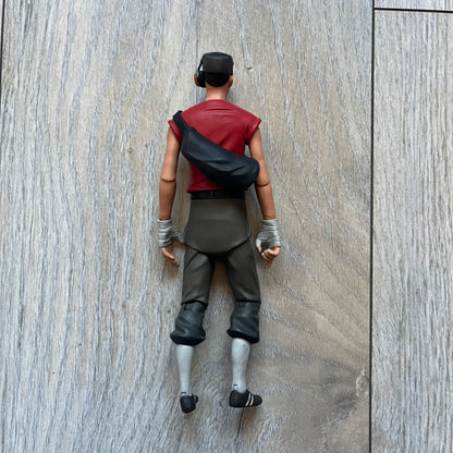 NECA Team Fortress 2 RED Scout Series 4 action figure from 2018. The figure measures approximately 7 inches in scale and recreates the Scout character from Valve’s Team Fortress 2 with game-accurate styling. It features more than 25 points of articulation and comes with three weapons: a scattergun, pistol, and bat.