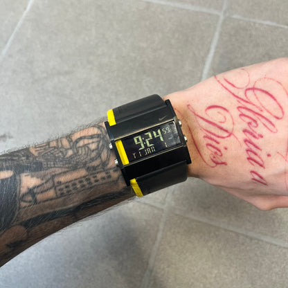 Nike 10//2 Lance Armstrong 2005 Signature Digital Watch features a black stainless steel case with a black LCD display and a black waterproof leather strap with a bright yellow accent. It has a 100-hour chronograph, interval timer, three time alarms, hydration alarm, and data recall, with water resistance to 100 meters. The strap has engraved date and time markings, and the watch comes with the original box and papers.
