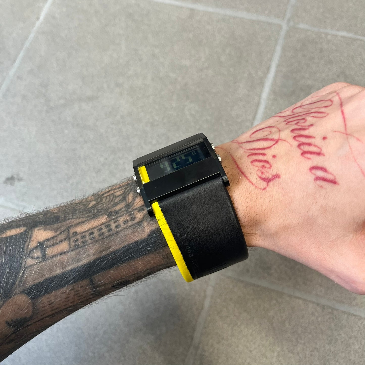 Nike 10//2 Lance Armstrong 2005 Signature Digital Watch features a black stainless steel case with a black LCD display and a black waterproof leather strap with a bright yellow accent. It has a 100-hour chronograph, interval timer, three time alarms, hydration alarm, and data recall, with water resistance to 100 meters. The strap has engraved date and time markings, and the watch comes with the original box and papers.
