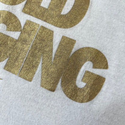Nike 2012 Olympics “Gold Digging” White Tee features a white slim-fit T-shirt with gold “Gold Digging” text on the front and a small Nike logo underneath. The design was released in connection with the 2012 Olympics and was later discontinued following controversy surrounding the wording.