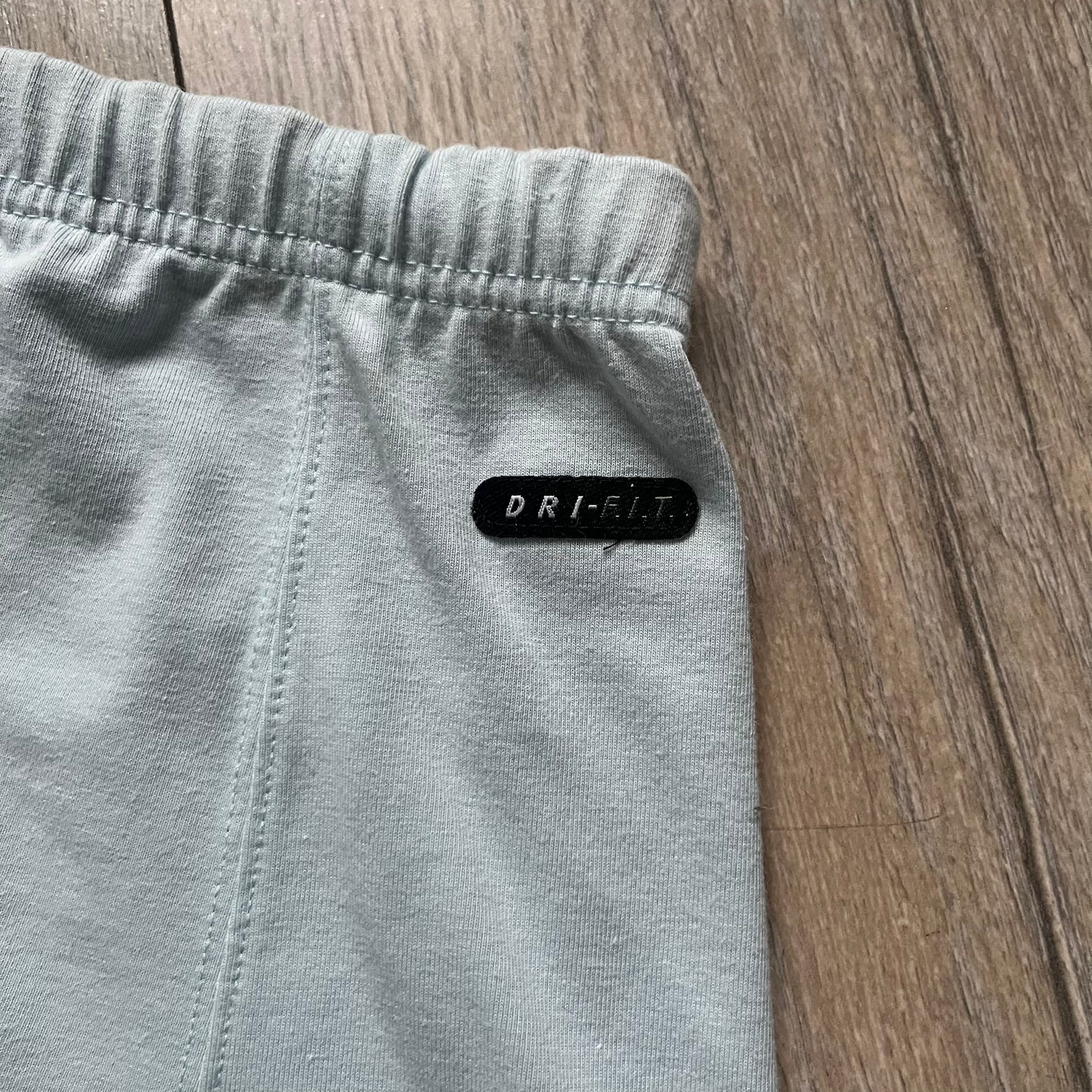 Nike 90’s Challenge Court Tennis Skirt is a baby blue women’s tennis skirt made in Thailand. It features a small green and red Nike Court logo patch at the lower hem, a Dri-FIT patch at the top, and an adjustable waistband with drawstrings.&nbsp;