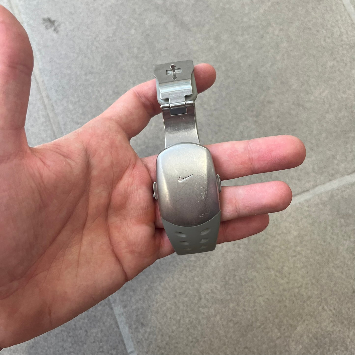 Nike Cayman WW0006 Dive Analog Watch features a grey polyurethane/rubber strap, silver rotating dive bezel, and a grey and white analog dial. It has a Japanese quartz movement, date indicator, luminous hands and hour markers, and 200-meter water resistance.

