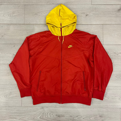 Nike China Olympics Split Windbreaker from 2008, crafted in red with a yellow hood representing China colors. This innovative jacket can be zipped apart on both sides and merged with other compatible models. This jacket doesn't have typical flags in the pockets.