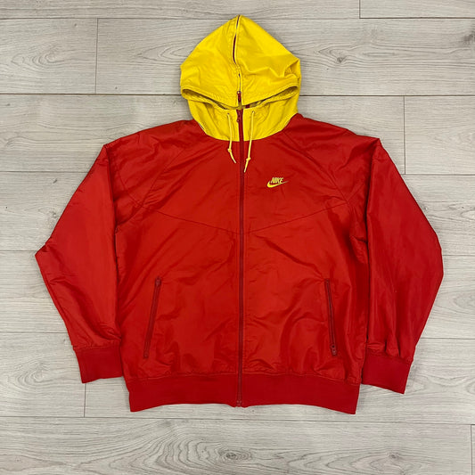 Nike China Olympics Split Windbreaker from 2008, crafted in red with a yellow hood representing China colors. This innovative jacket can be zipped apart on both sides and merged with other compatible models. This jacket doesn't have typical flags in the pockets.