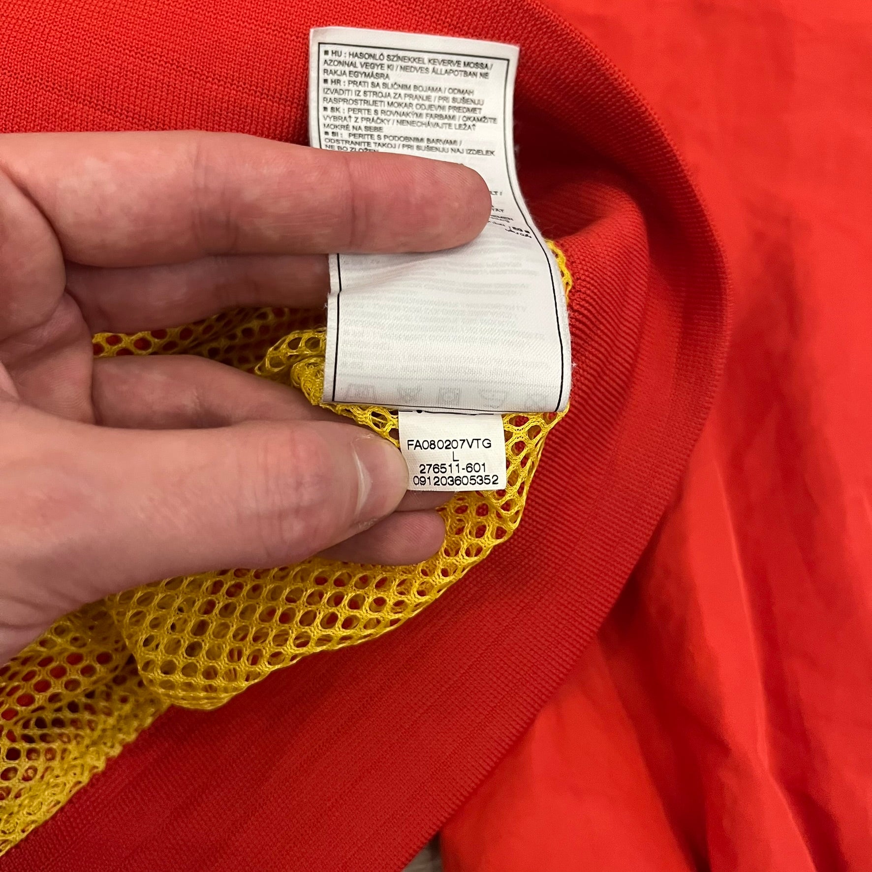 Nike China Olympics Split Windbreaker from 2008, crafted in red with a yellow hood representing China colors. This innovative jacket can be zipped apart on both sides and merged with other compatible models. This jacket doesn't have typical flags in the pockets.