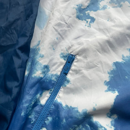 Nike Cloud Day Split Windbreaker from the 2010s in full blue with a photorealistic all-over cloud print. Features dual zippers on the front and back, allowing the jacket to split in half and merge with other compatible pieces. Made from 100% nylon.