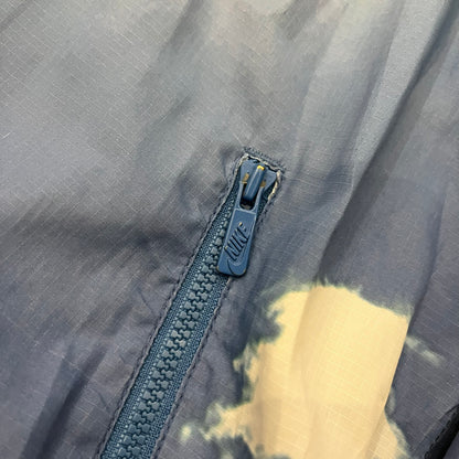Nike Cloud Day Split Windbreaker from the 2010s in full blue with a photorealistic all-over cloud print. Features dual zippers on the front and back, allowing the jacket to split in half and merge with other compatible pieces. Made from 100% nylon.
