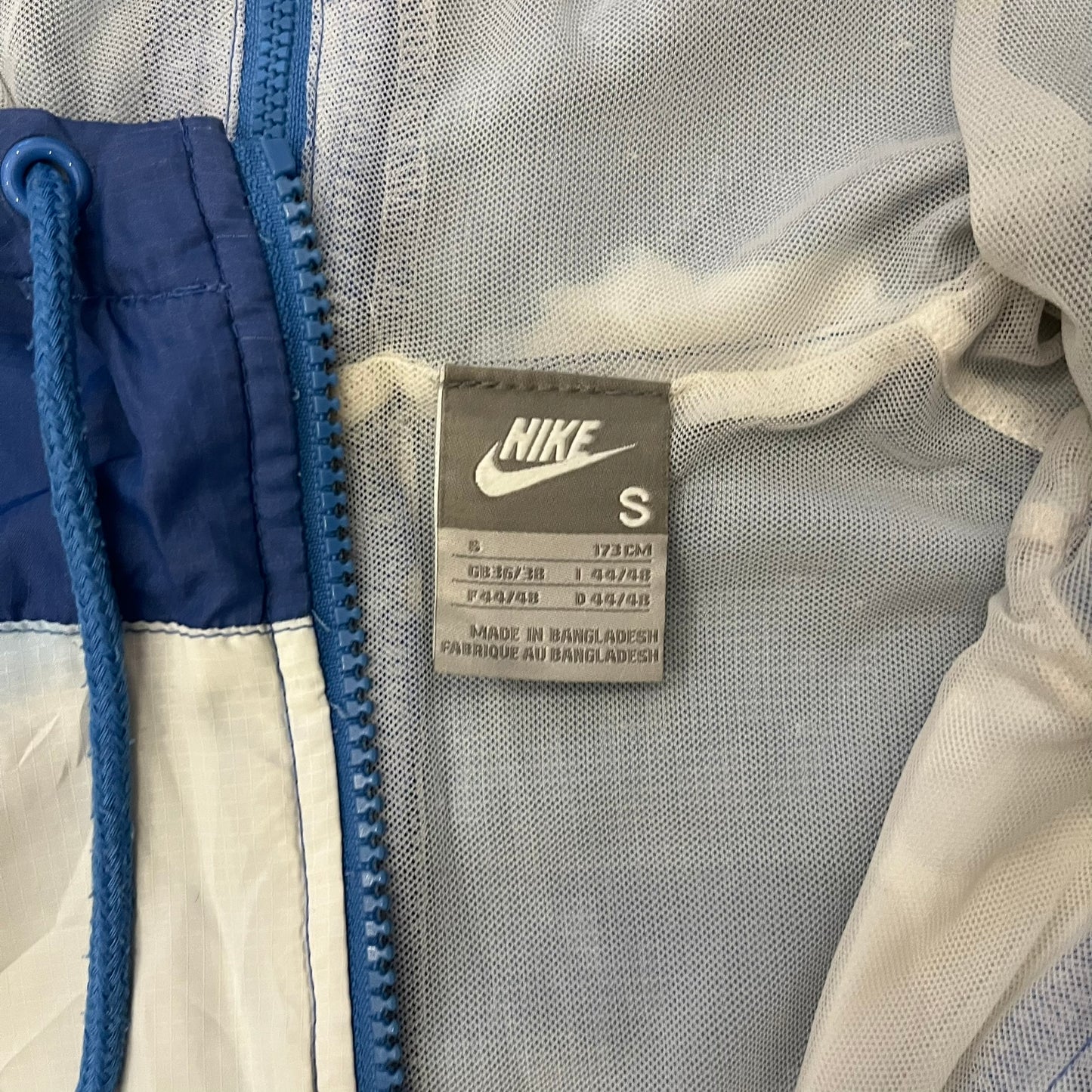 Nike Cloud Day Split Windbreaker from the 2010s in full blue with a photorealistic all-over cloud print. Features dual zippers on the front and back, allowing the jacket to split in half and merge with other compatible pieces. Made from 100% nylon.