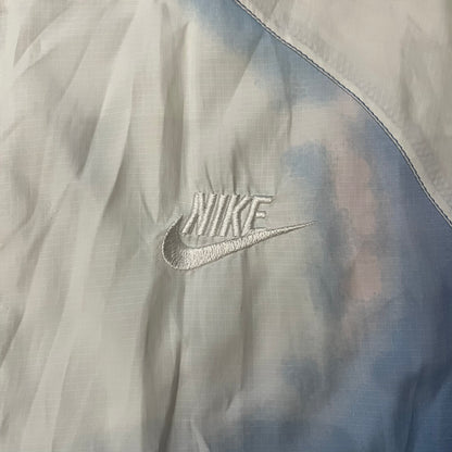Nike Cloud Day Split Windbreaker from the 2010s in full blue with a photorealistic all-over cloud print. Features dual zippers on the front and back, allowing the jacket to split in half and merge with other compatible pieces. Made from 100% nylon.