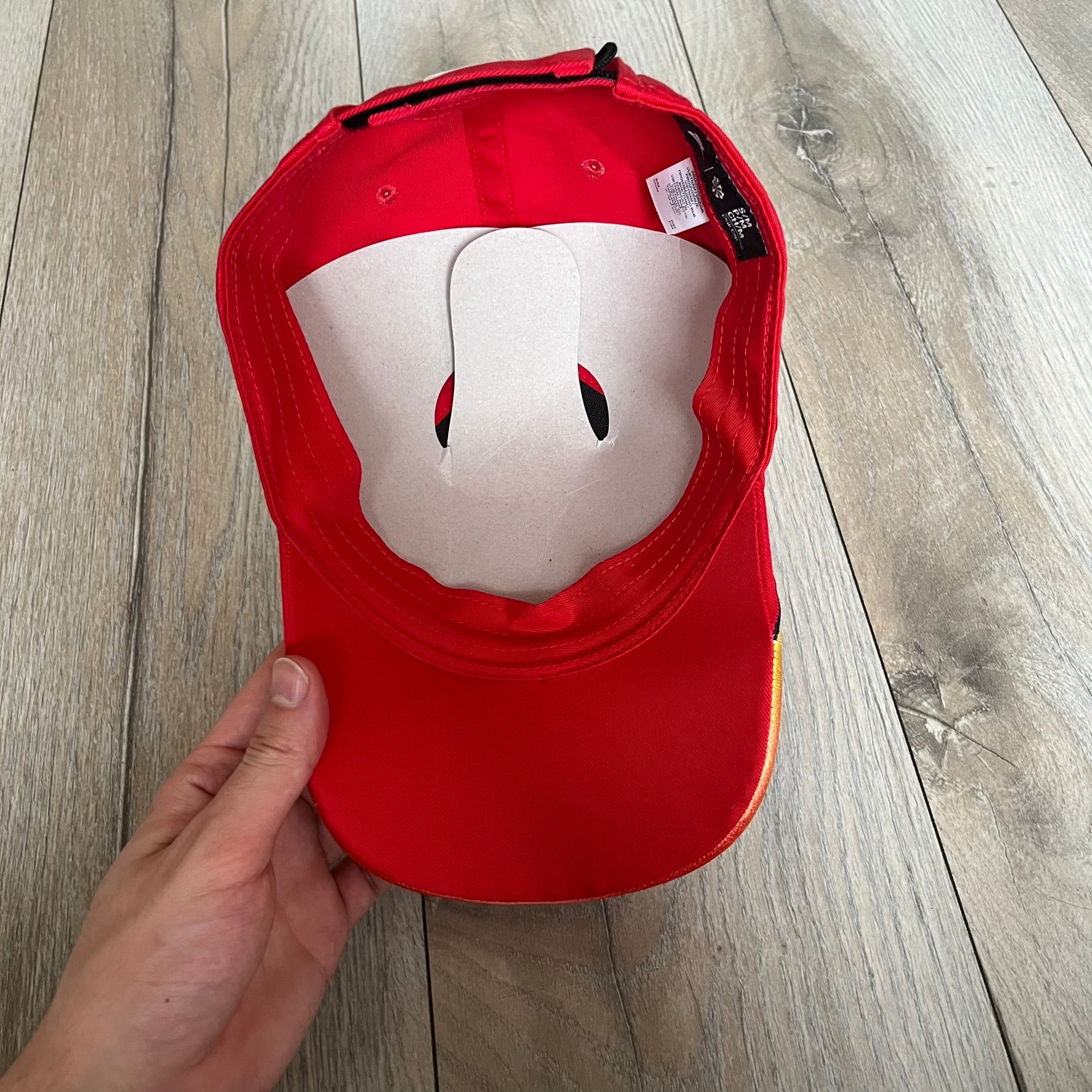 Nike Club Semi-Structured OG University Red Flame Cap is a red baseball cap featuring a white Nike Swoosh centered on the front panel. Embroidered flame graphics in orange, yellow, and red extend across the front of the visor and side panels. A small white Nike Swoosh is placed at the back. The design is identified by code IH9258-657.&nbsp;