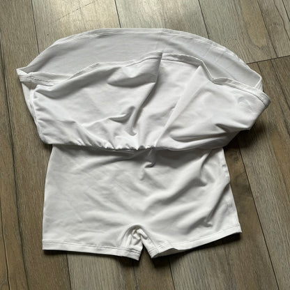 Nike Court Victory Tennis Skirt is a kids’ tennis skort with built-in inner shorts for coverage. The skirt features a textured fabric with fine linear detailing, while the waistband remains smooth, and a black Nike Swoosh is placed at the lower hem. The design includes a pleated section.