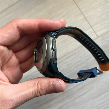 Nike Sports Chrono Cross Training Watch (WX0015) featuring a unique ana-digi “Covert” design with a partial hood over the analog dial. The display combines a three-hand analog setup with a curved dual-section LCD showing time, day, and mode. Water-resistant up to 50m and equipped with chronograph, timer, alarm, and dual-time functions, this model reflects Nike’s peak era of performance-driven digital innovation.