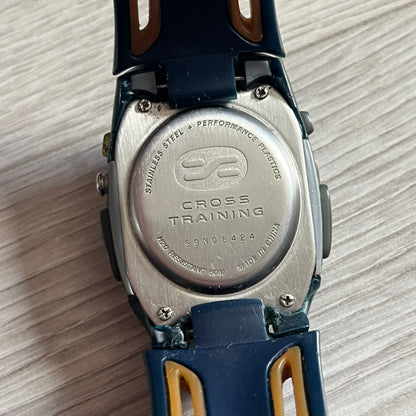 Nike Sports Chrono Cross Training Watch (WX0015) featuring a unique ana-digi “Covert” design with a partial hood over the analog dial. The display combines a three-hand analog setup with a curved dual-section LCD showing time, day, and mode. Water-resistant up to 50m and equipped with chronograph, timer, alarm, and dual-time functions, this model reflects Nike’s peak era of performance-driven digital innovation.