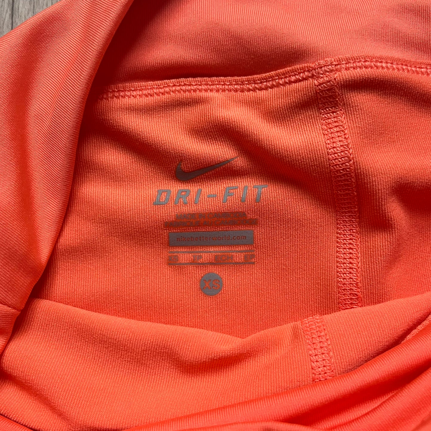 Nike Dri-FIT Orange Tennis Skirt is a women’s tennis skort with built-in shorts for coverage and support. The skirt is finished in orange with lighter side panels and embroidered Nike Swoosh at the lower hem. A small Nike Court logo on the side highlights its connection to Nike’s performance tennis line.