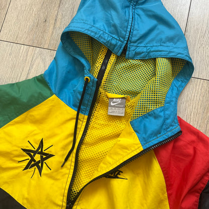 Nike Ethiopia Olympics 2008 Split Windbreaker is a performance jacket designed by Jarrett Reynolds for the Olympic collection. The jacket features a black lower section, yellow upper body, blue hood, green shoulder and red opposite shoulder. The chest is finished with an embroidered Nike logo and Ethiopia emblem. The jacket features a unique split construction that allows it to be unzipped along both sides and connected with other compatible jackets. Hidden inside, a small Ethiopia flags accent completes th