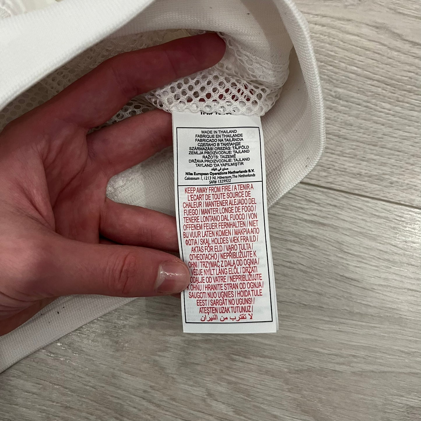 The Nike France Olympics 2008 Split Windbreaker made in a white, red, and navy color block representing France, it includes a red embroidered Nike logo and hidden French flags inside both pockets. It features a modular design by Jarrett Reynolds, allowing the jacket to split on both sides via dual zippers.