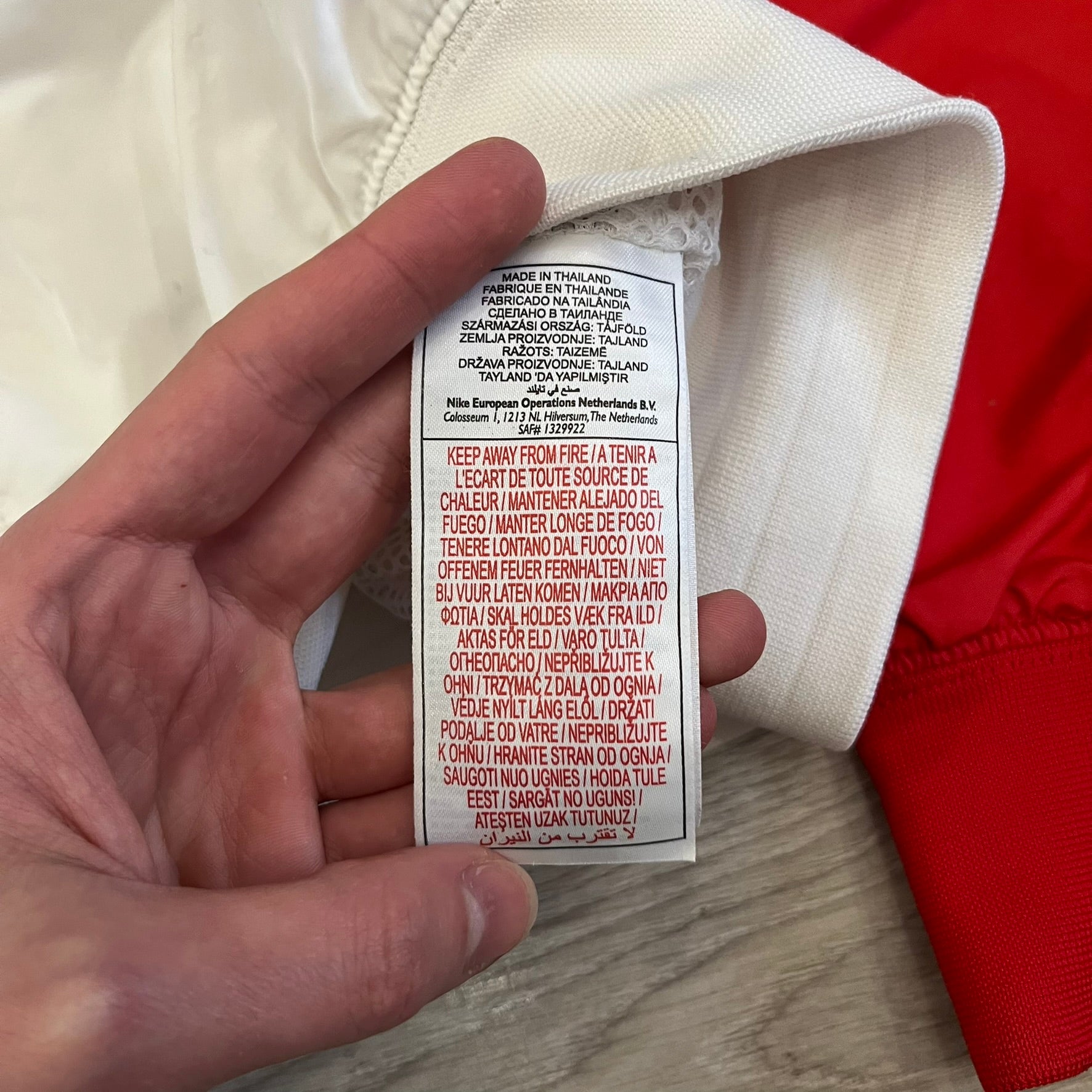 The Nike France Olympics 2008 Split Windbreaker made in a white, red, and navy color block representing France, it includes a red embroidered Nike logo and hidden French flags inside both pockets. It features a modular design by Jarrett Reynolds, allowing the jacket to split on both sides via dual zippers.
