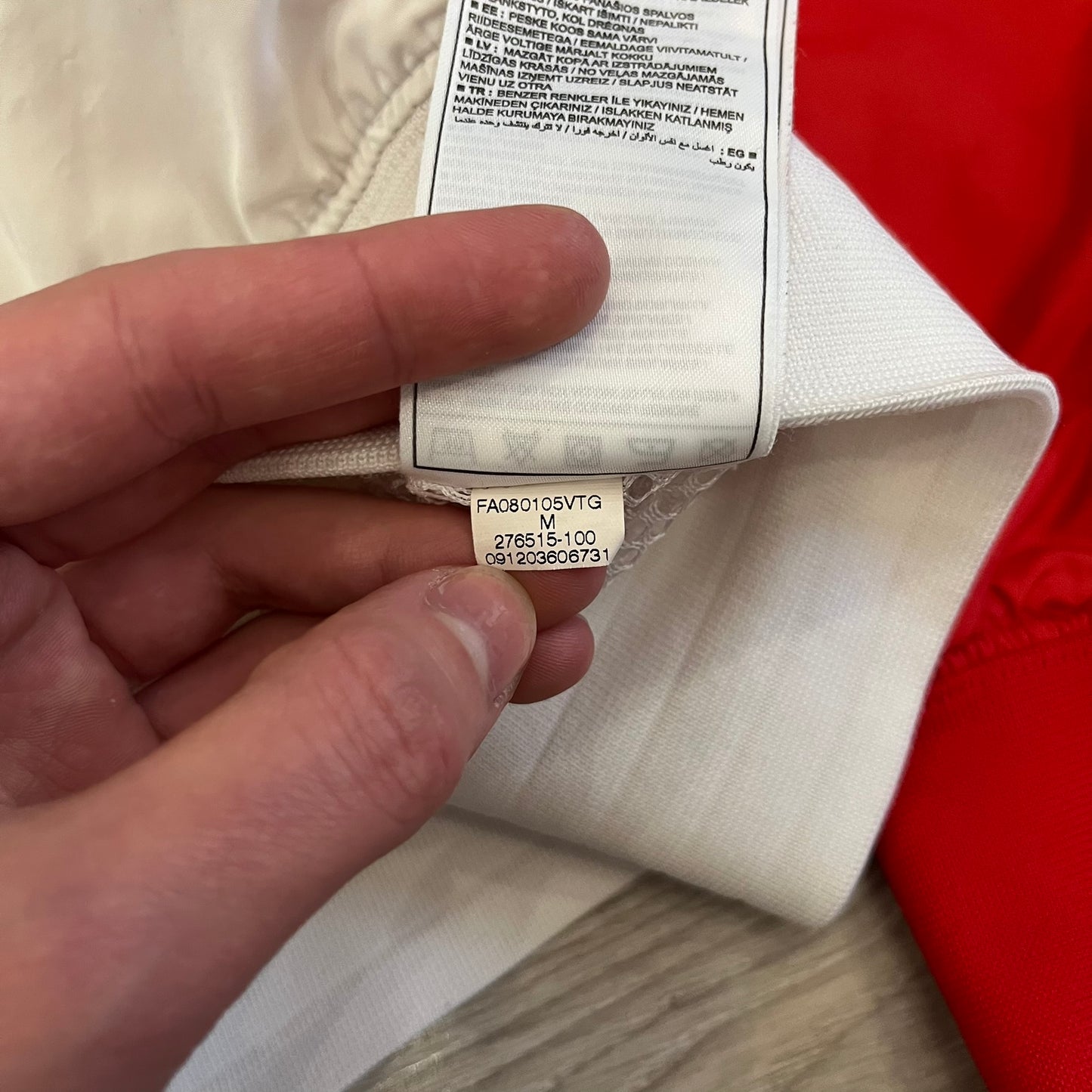 The Nike France Olympics 2008 Split Windbreaker made in a white, red, and navy color block representing France, it includes a red embroidered Nike logo and hidden French flags inside both pockets. It features a modular design by Jarrett Reynolds, allowing the jacket to split on both sides via dual zippers.