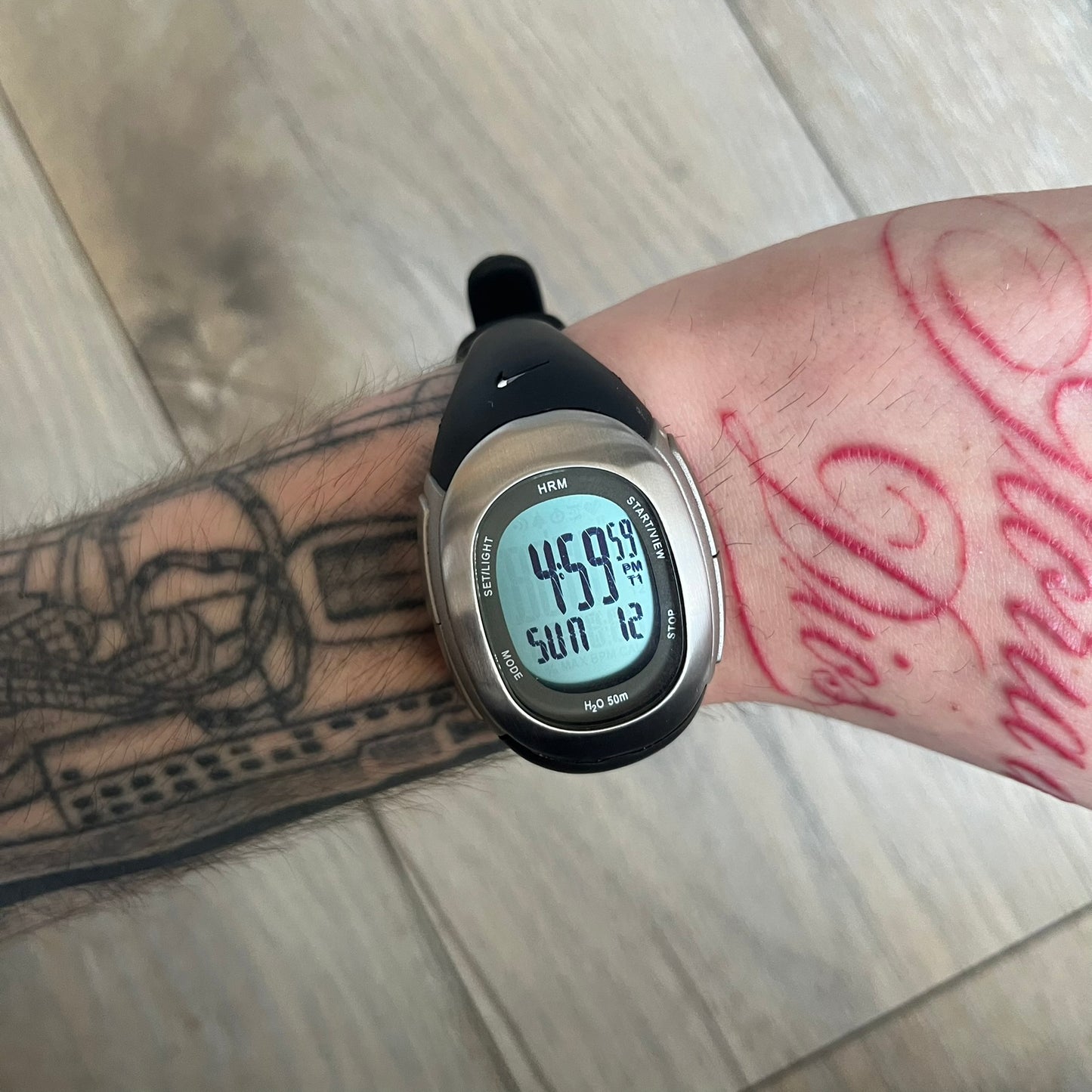 Nike Imara HRM SM0032 Digital Watch is a digital wristwatch featuring a silver case with gray-outlined display and a black rubber strap. The watch includes backlight functionality, multiple modes, and a chest heart rate monitor, with water resistance up to 59 meters. It comes with original box, papers, and a plastic store display.