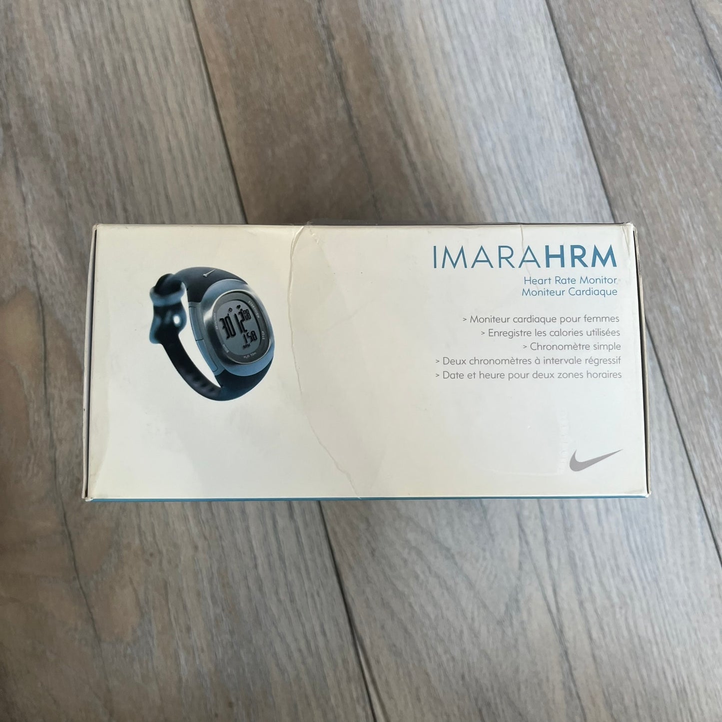 Nike Imara HRM SM0032 Digital Watch is a digital wristwatch featuring a silver case with gray-outlined display and a black rubber strap. The watch includes backlight functionality, multiple modes, and a chest heart rate monitor, with water resistance up to 59 meters. It comes with original box, papers, and a plastic store display.