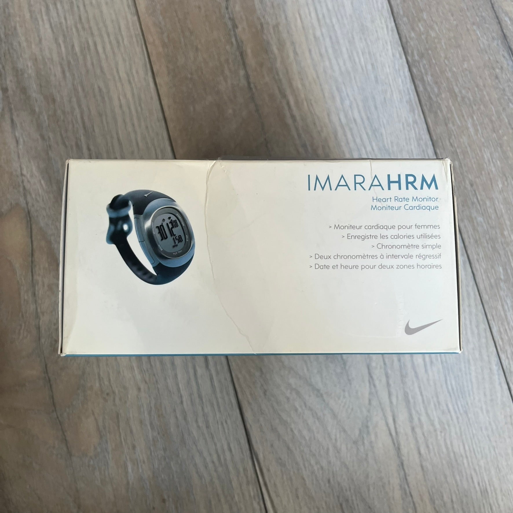 Nike Imara HRM SM0032 Digital Watch is a digital wristwatch featuring a silver case with gray-outlined display and a black rubber strap. The watch includes backlight functionality, multiple modes, and a chest heart rate monitor, with water resistance up to 59 meters. It comes with original box, papers, and a plastic store display.