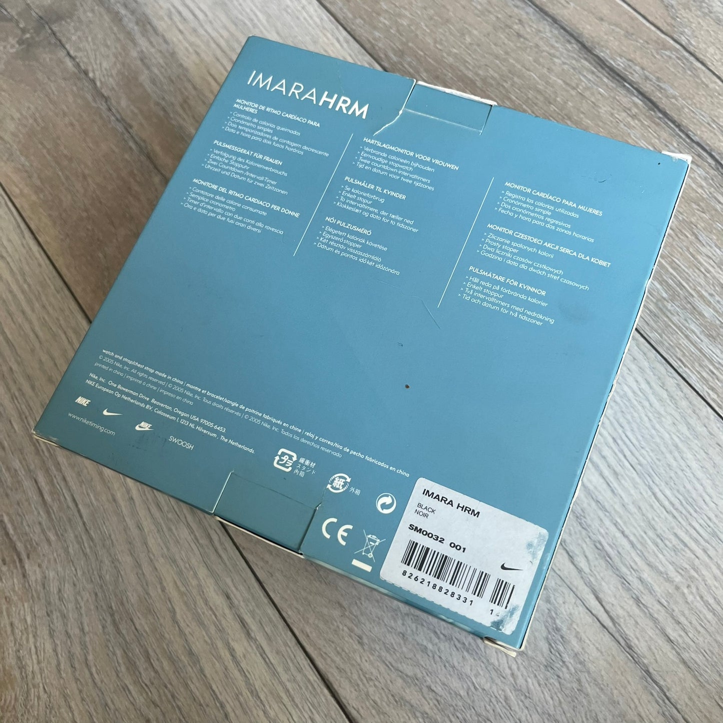 Nike Imara HRM SM0032 Digital Watch is a digital wristwatch featuring a silver case with gray-outlined display and a black rubber strap. The watch includes backlight functionality, multiple modes, and a chest heart rate monitor, with water resistance up to 59 meters. It comes with original box, papers, and a plastic store display.