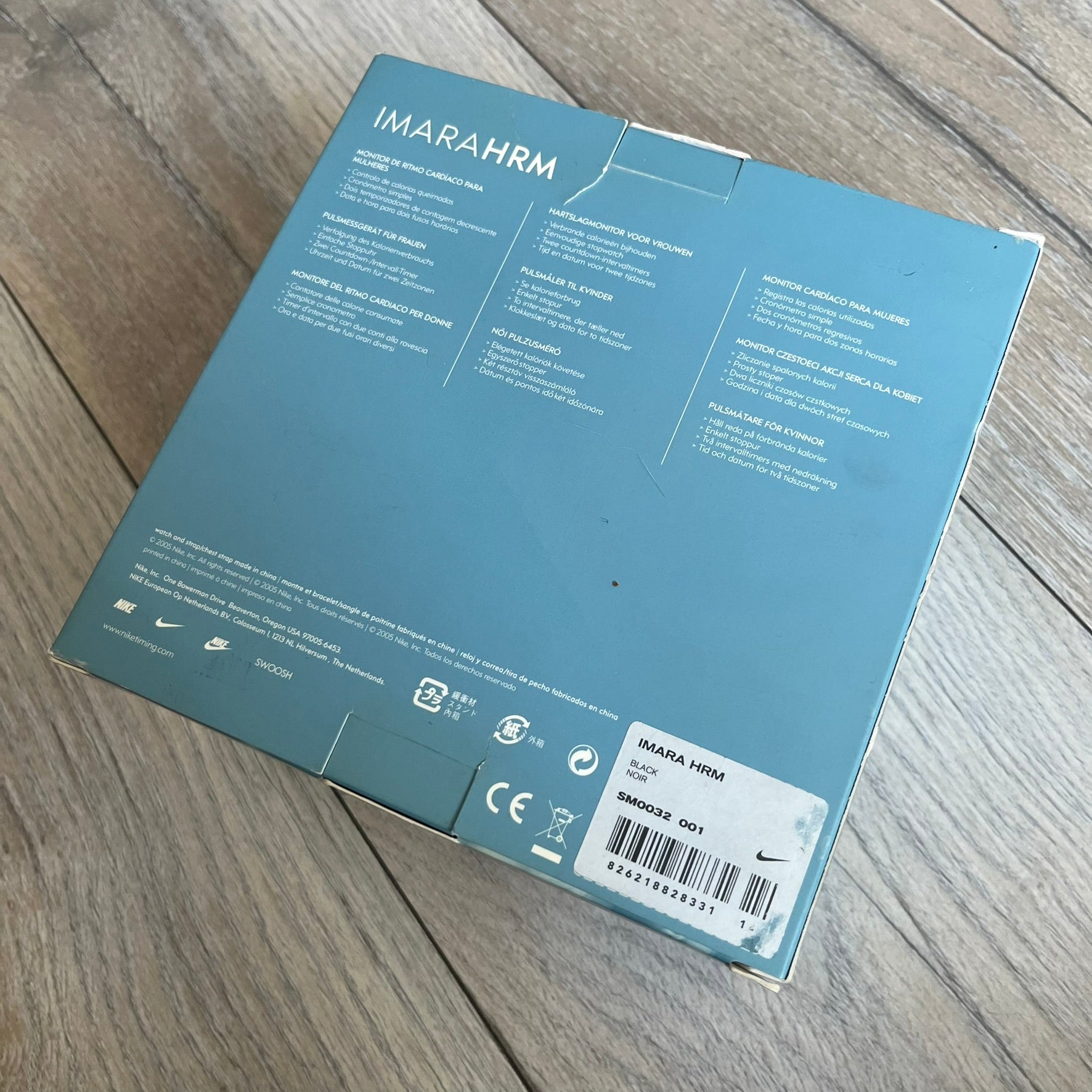 Nike Imara HRM SM0032 Digital Watch is a digital wristwatch featuring a silver case with gray-outlined display and a black rubber strap. The watch includes backlight functionality, multiple modes, and a chest heart rate monitor, with water resistance up to 59 meters. It comes with original box, papers, and a plastic store display.