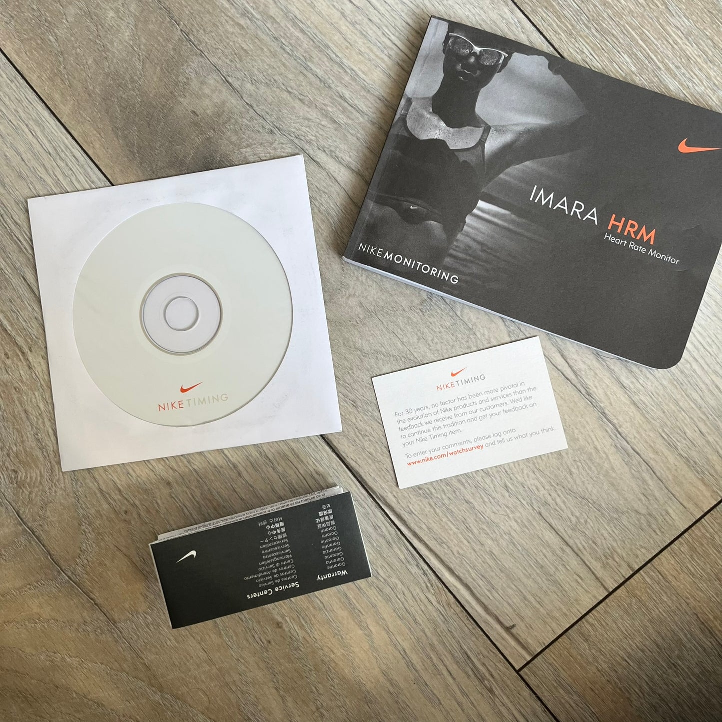 Nike Imara HRM SM0032 Digital Watch is a digital wristwatch featuring a silver case with gray-outlined display and a black rubber strap. The watch includes backlight functionality, multiple modes, and a chest heart rate monitor, with water resistance up to 59 meters. It comes with original box, papers, and a plastic store display.