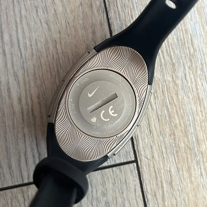 Nike Imara HRM SM0032 Digital Watch is a digital wristwatch featuring a silver case with gray-outlined display and a black rubber strap. The watch includes backlight functionality, multiple modes, and a chest heart rate monitor, with water resistance up to 59 meters. It comes with original box, papers, and a plastic store display.