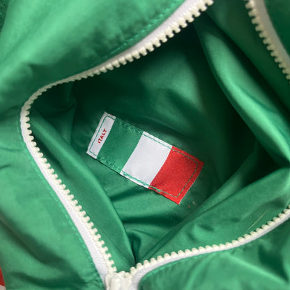 Nike Italy Olympics Split Windbreaker from 2008, created by designer Jarrett Reynolds. Crafted in green/white/red, with a green lower half of the front and sleeves, white upper half and red hood. This innovative jacket can be zipped apart on both sides and merged with other compatible models. Hidden inside, a small Italy flags accent completes the concept.