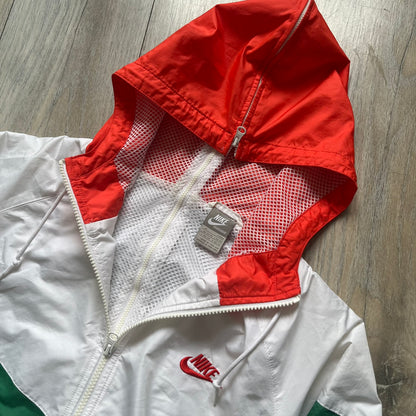 Nike Italy Olympics Split Windbreaker from 2008, created by designer Jarrett Reynolds. Crafted in green/white/red, with a green lower half of the front and sleeves, white upper half and red hood. This innovative jacket can be zipped apart on both sides and merged with other compatible models. Hidden inside, a small Italy flags accent completes the concept.