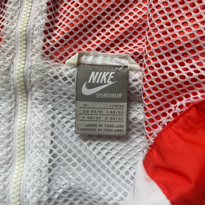 Nike Italy Olympics Split Windbreaker from 2008, created by designer Jarrett Reynolds. Crafted in green/white/red, with a green lower half of the front and sleeves, white upper half and red hood. This innovative jacket can be zipped apart on both sides and merged with other compatible models. Hidden inside, a small Italy flags accent completes the concept.