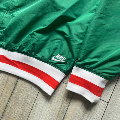 Nike Italy Olympics Split Windbreaker from 2008, created by designer Jarrett Reynolds. Crafted in green/white/red, with a green lower half of the front and sleeves, white upper half and red hood. This innovative jacket can be zipped apart on both sides and merged with other compatible models. Hidden inside, a small Italy flags accent completes the concept.