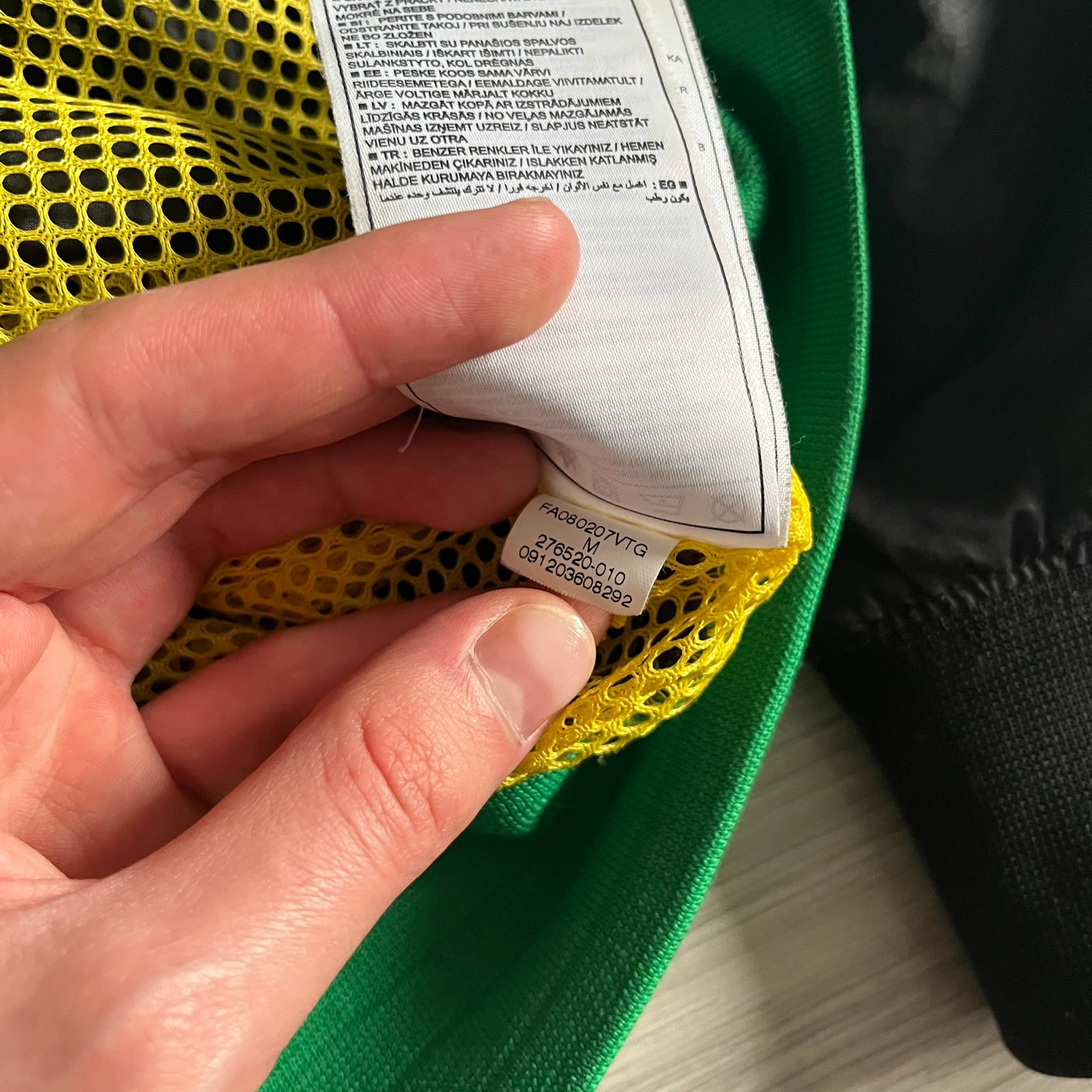 Nike Jamaica Olympics 2008 Split Windbreaker designed by Jarrett Reynolds. Features a black base with a yellow cross on the front inspired by the Jamaican flag. Green bottom hem and details. Dual side zippers allow the jacket to split in half and be combined with other pieces from the collection, with a small Jamaica flag detail inside the pocket.