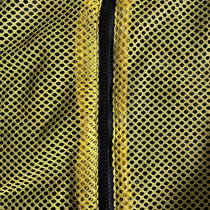 Nike Jamaica Olympics 2008 Split Windbreaker designed by Jarrett Reynolds. Features a black base with a yellow cross on the front inspired by the Jamaican flag. Green bottom hem and details. Dual side zippers allow the jacket to split in half and be combined with other pieces from the collection, with a small Jamaica flag detail inside the pocket.