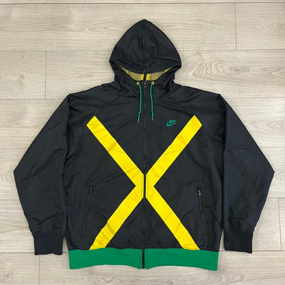 Nike Jamaica Olympics 2008 Split Windbreaker designed by Jarrett Reynolds. Features a black base with a yellow cross on the front inspired by the Jamaican flag. Green bottom hem and details. Dual side zippers allow the jacket to split in half and be combined with other pieces from the collection, with a small Jamaica flags detail inside the pocket.