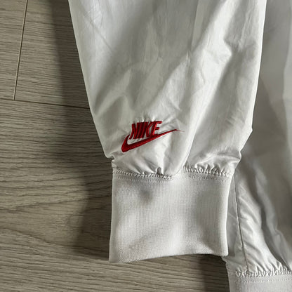 Nike Japan Olympics Split Windbreaker from 2008, created by designer Jarrett Reynolds. Crafted in white with a large red circle representing Japan’s flag, this innovative jacket can be zipped apart on both sides and merged with other compatible models. Hidden inside, a small Japan flag accent completes the concept.
