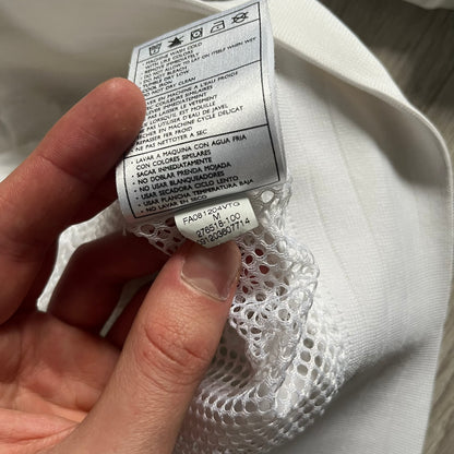 Nike Japan Olympics Split Windbreaker from 2008, created by designer Jarrett Reynolds. Crafted in white with a large red circle representing Japan’s flag, this innovative jacket can be zipped apart on both sides and merged with other compatible models. Hidden inside, a small Japan flag accent completes the concept.