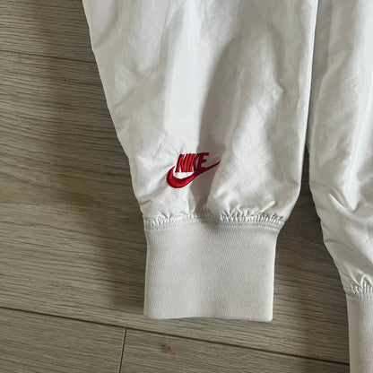 Nike Japan Olympics Split Windbreaker from 2008, created by designer Jarrett Reynolds. Crafted in white with a large red circle representing Japan’s flag, this innovative jacket can be zipped apart on both sides and merged with other compatible models. Hidden inside, a small Japan flags accent completes the concept.