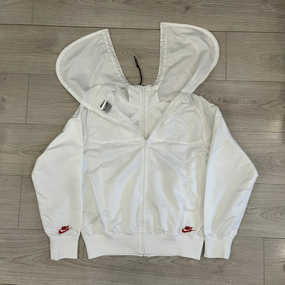 Nike Japan Olympics Split Windbreaker from 2008, created by designer Jarrett Reynolds. Crafted in white with a large red circle representing Japan’s flag, this innovative jacket can be zipped apart on both sides and merged with other compatible models. Hidden inside, a small Japan flags accent completes the concept.
