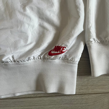 Nike Japan Olympics Split Windbreaker from 2008, created by designer Jarrett Reynolds. Crafted in white with a large red circle representing Japan’s flag, this innovative jacket can be zipped apart on both sides and merged with other compatible models. Hidden inside, a small Japan flags accent completes the concept.