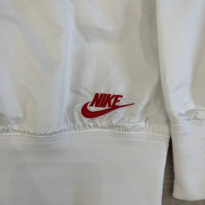 Nike Japan Olympics Split Windbreaker from 2008, created by designer Jarrett Reynolds. Crafted in white with a large red circle representing Japan’s flag, this innovative jacket can be zipped apart on both sides and merged with other compatible models. Hidden inside, a small Japan flags accent completes the concept.