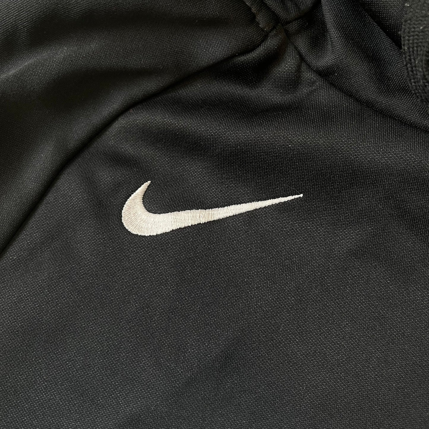 Nike MLG (Major League Gaming) Black Hoodie is a performance hoodie made from 100% polyester with Nike Dri-FIT technology. It features a kangaroo pocket, a Nike Swoosh on the upper right chest, and a large Major League Gaming (MLG) logo across the center with the iconic red and blue gamepad graphic. The hood has a raised front design that extends to cover the mouth.
