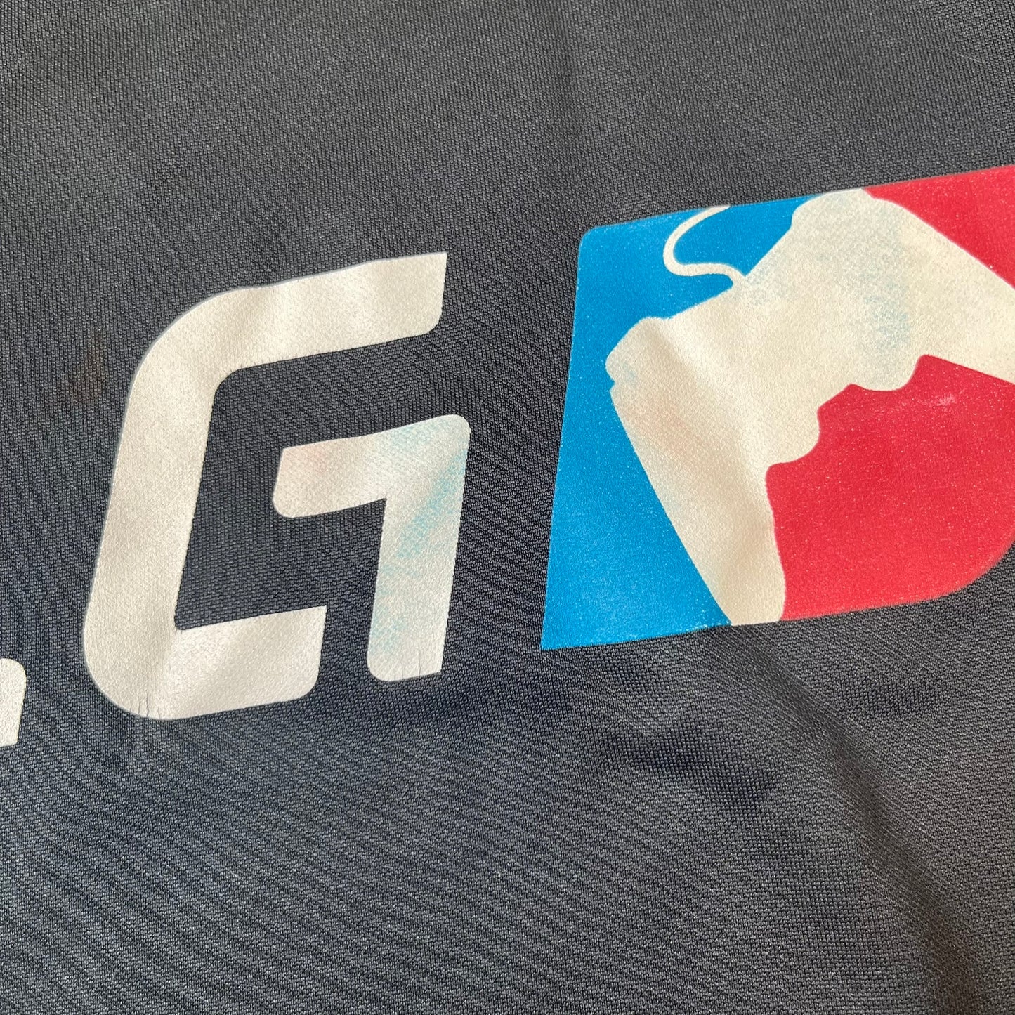 Nike MLG (Major League Gaming) Black Hoodie is a performance hoodie made from 100% polyester with Nike Dri-FIT technology. It features a kangaroo pocket, a Nike Swoosh on the upper right chest, and a large Major League Gaming (MLG) logo across the center with the iconic red and blue gamepad graphic. The hood has a raised front design that extends to cover the mouth.