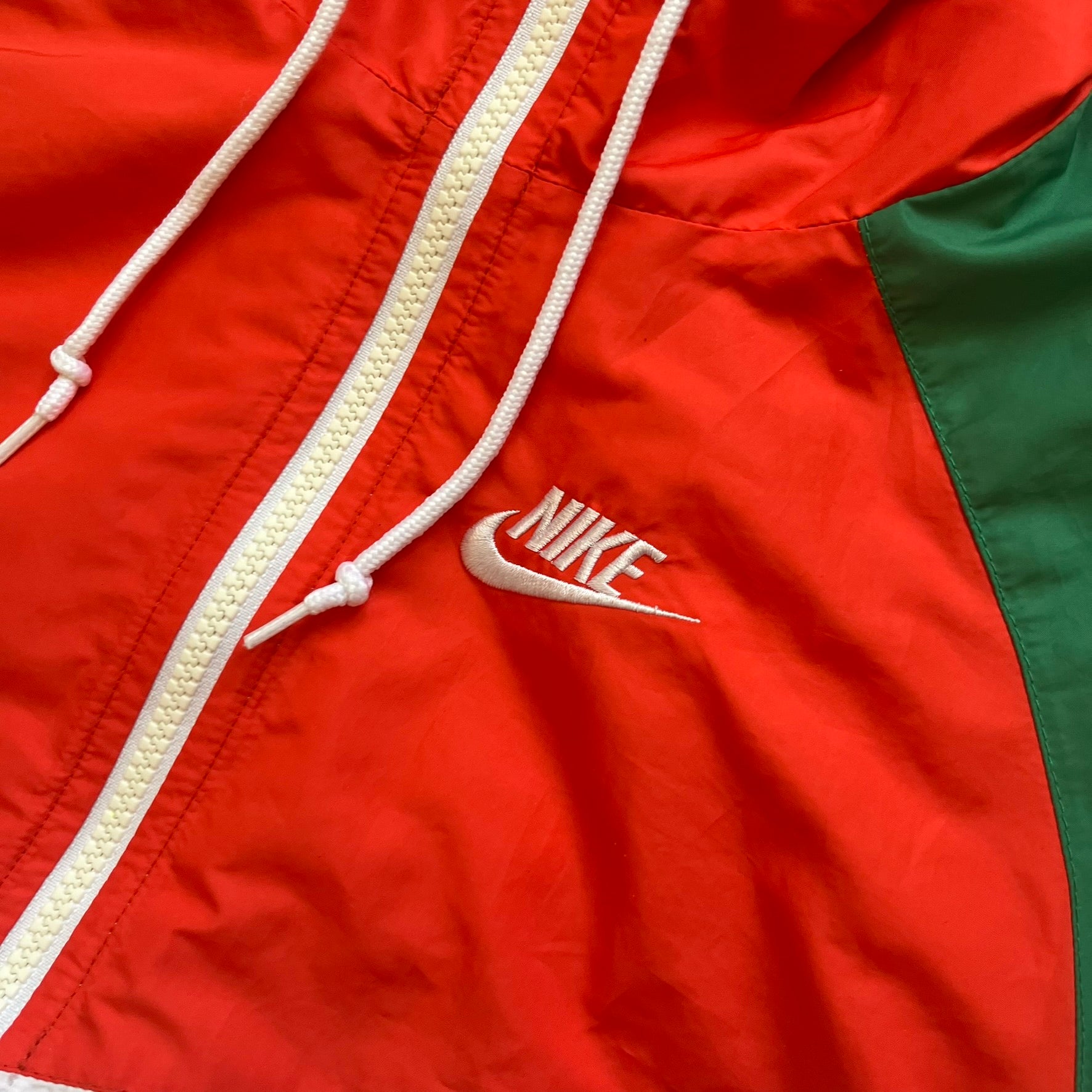 Nike Mexico Olympics Split Windbreaker from 2008, created by designer Jarrett Reynolds. Crafted in green/white/red, with a white lower half, red upper half and green hems/shoulders. Small Nike red embroidery finishes the jacket design. This innovative jacket can be zipped apart on both sides and merged with other compatible models.